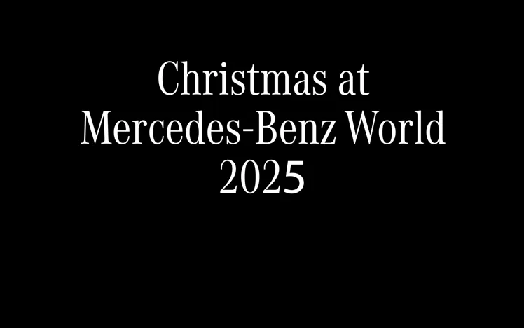 Festively decorated event space at Mercedes-Benz World, set for a Christmas celebration with elegant tables and ambient lighting.