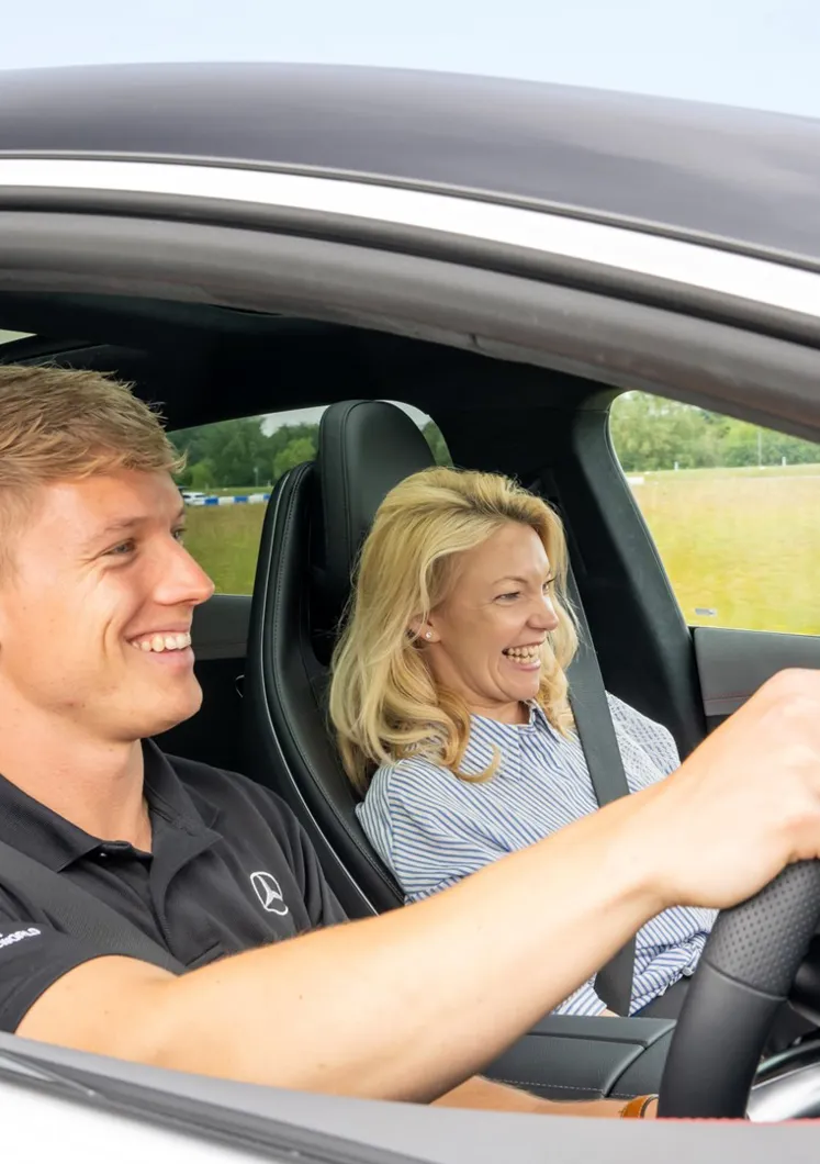 Pro Driver and passenger inside a Mercedes-AMG 63 during a high-speed ride at Mercedes-Benz World, capturing excitement and elite performance.